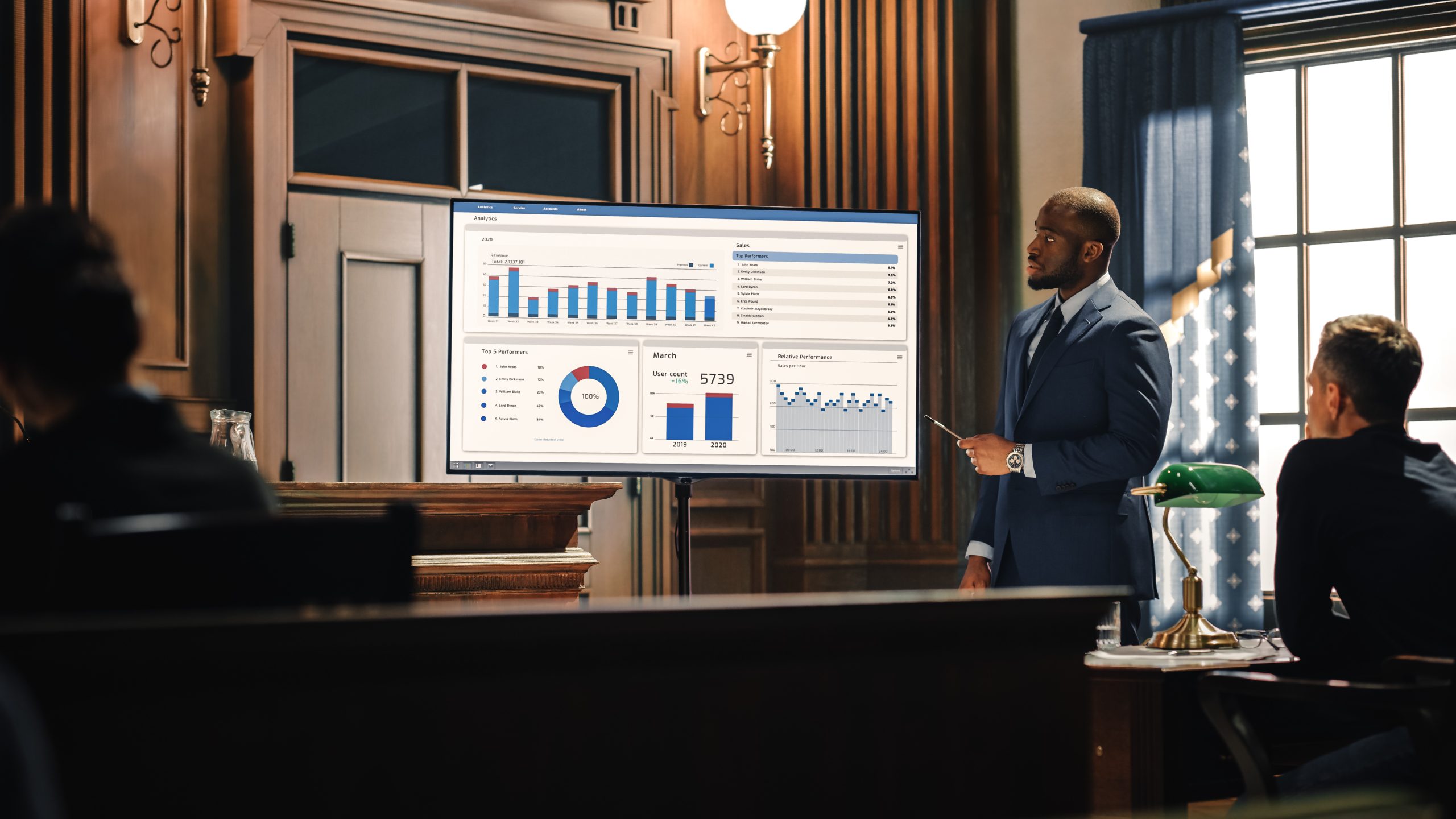 Court of Law Trial in Session: Portrait of Charismatic Male Public Defender Showing Analysis of Financal Crime on TV Screen to Judge and Jury. Attorney Lawyer Protecting Client, Presenting Case.