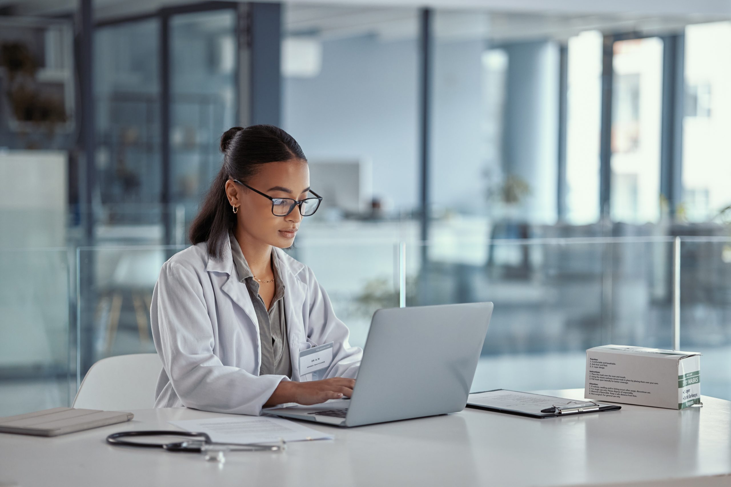 Shot of a young female doctor using a laptop at work